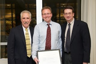 Photo of Tim holding his award